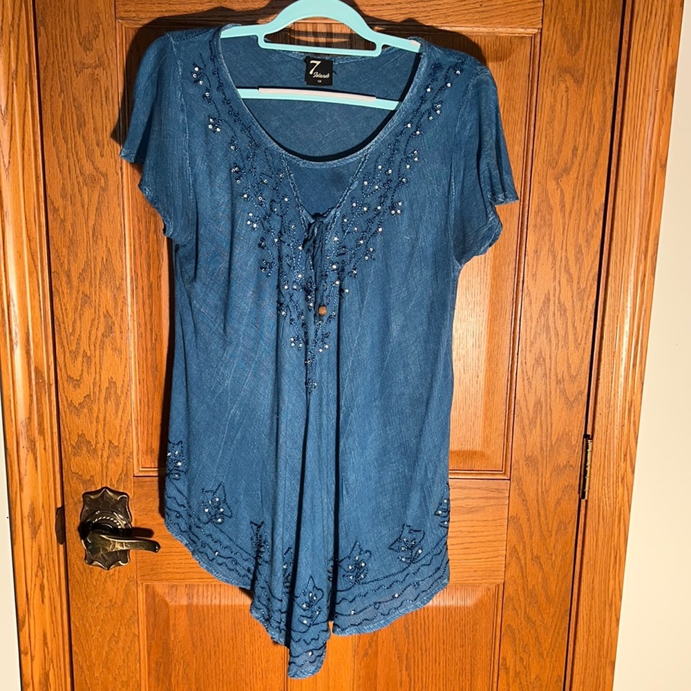 Rhinestones & embroidered decorate the front bodice & hem